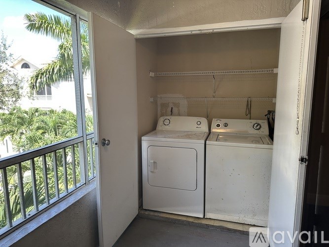 A small laundry room with a washer and dryer.