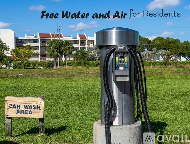 A car wash area sign is placed in front of a water and air dispenser.