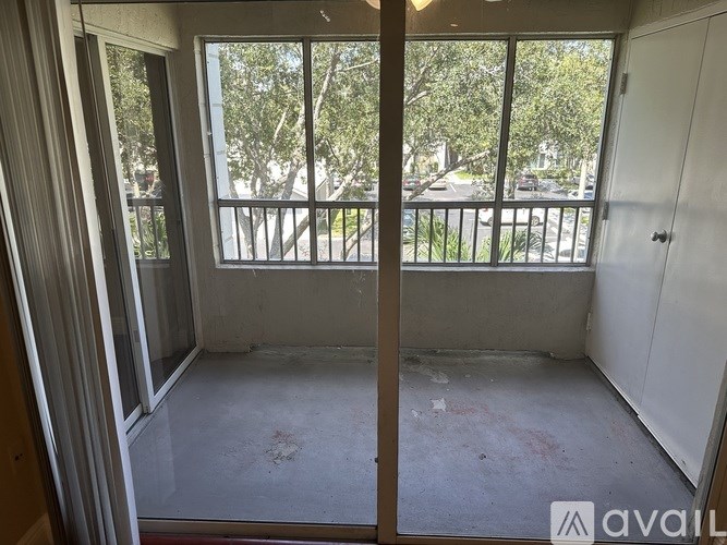 A room with a view of a street through a window.