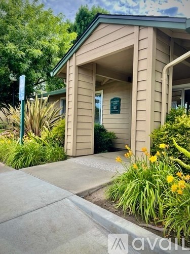 A small building with a green signboard on the window.