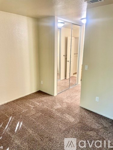 A room with a carpeted floor and a glass door.