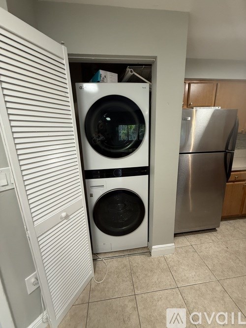 A washer and dryer are in a small laundry room.