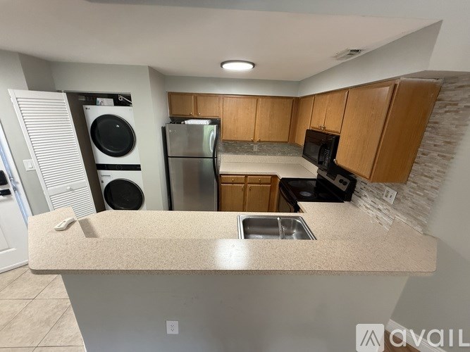 A kitchen with wooden cabinets and a granite countertop.