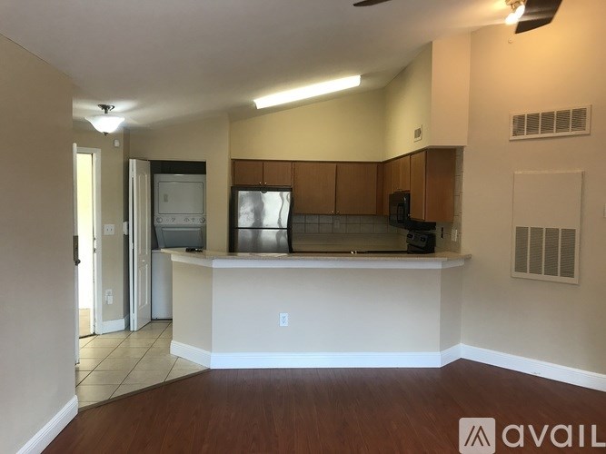 A kitchen area with a counter and cabinets.