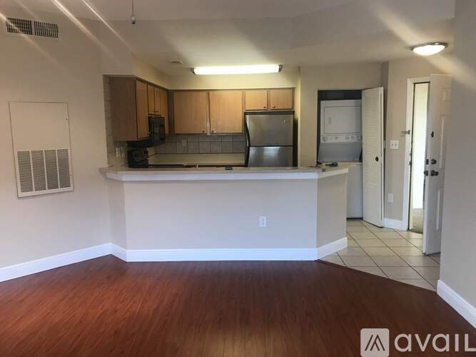 A kitchen area with wooden floors and a countertop.