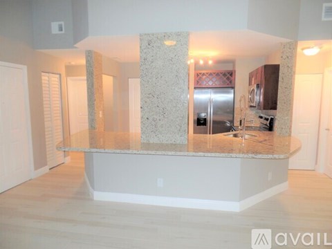 A kitchen with granite countertops and a central island.