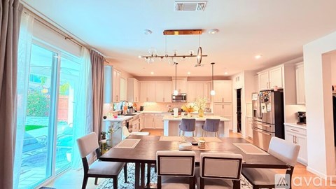 A modern kitchen with a dining table set for four.