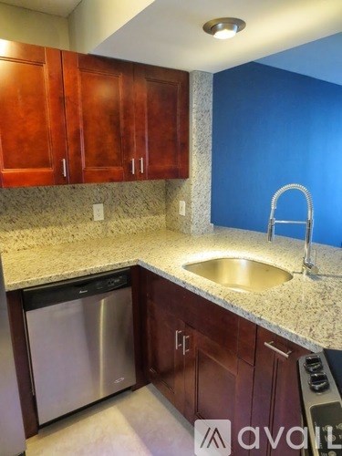 A kitchen with a sink and cabinets.