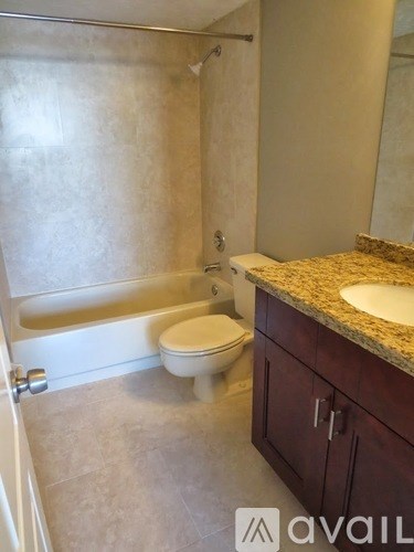 A bathroom with a toilet, sink, and bathtub.