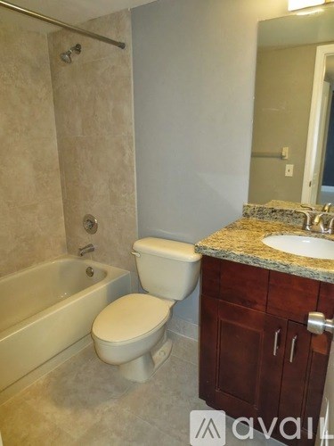 A bathroom with a tub, toilet and sink.