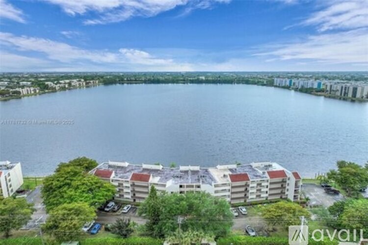 A large body of water is surrounded by apartment buildings.