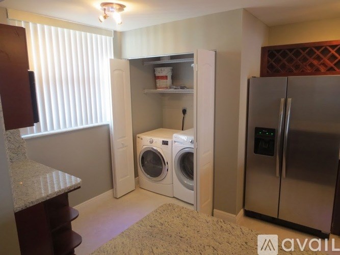 A small laundry room with a washer and dryer.