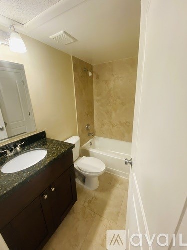 A bathroom with a sink, toilet and bathtub.