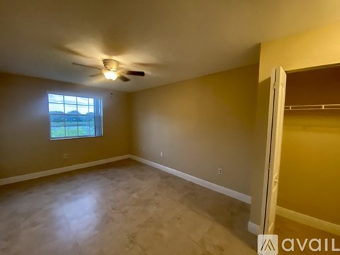 A room with a ceiling fan and a window.