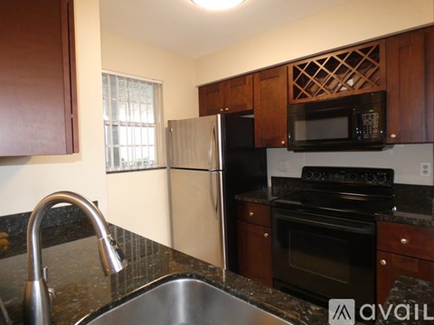 A kitchen with a black oven and microwave.