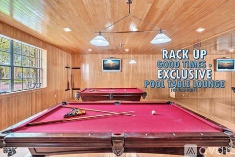 A pool table lounge for residents with a red pool table in the center.