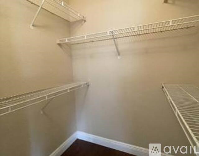 Empty white shelves in a room.
