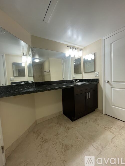 A bathroom with a vanity and a mirror.