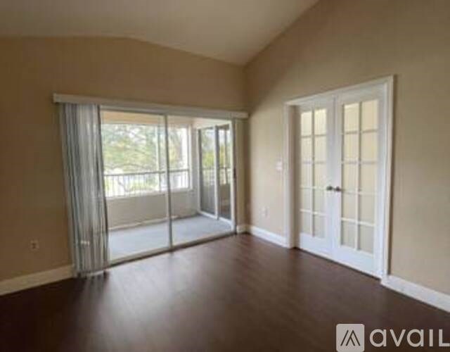 A room with a sliding glass door and a white door.
