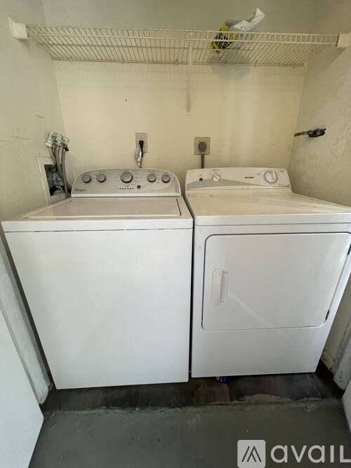 A small laundry room with a washer and dryer.