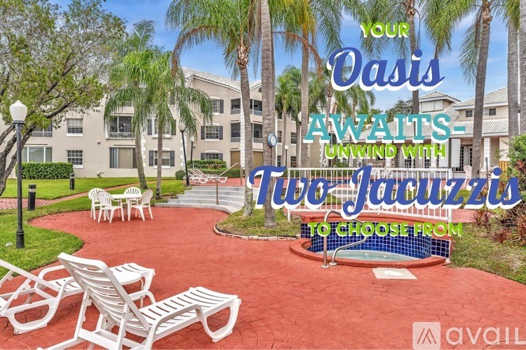 A red patio area with white chairs and a pool table in front of a building with palm trees.