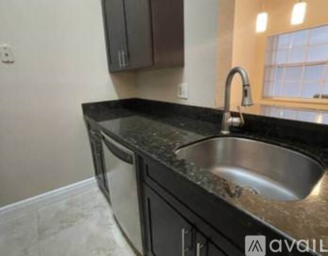 A kitchen with a sink and a window.