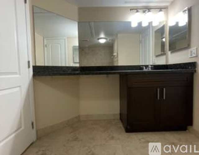 A bathroom vanity with a mirror above it.