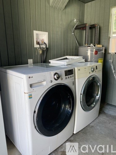 Two front loading washing machines in a laundry room.