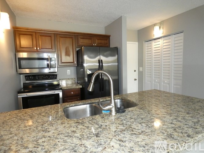 A kitchen with granite countertops and stainless steel appliances.
