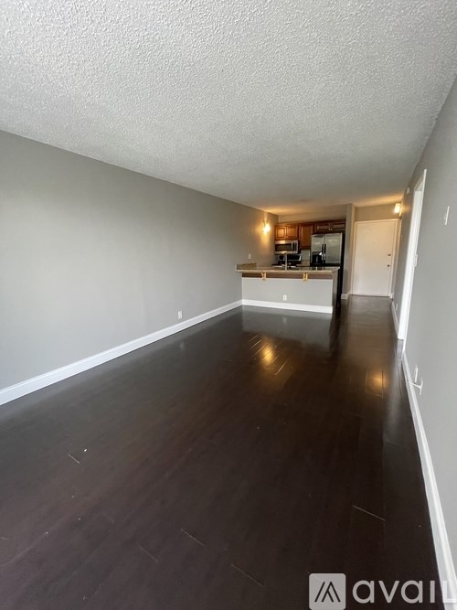 A room with wooden floors and white walls.