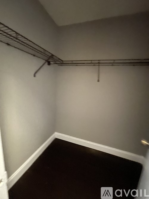 A small, empty room with a metal rack on the wall.