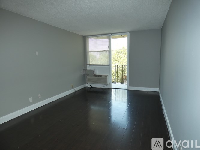 A room with a window and a balcony is available for rent.