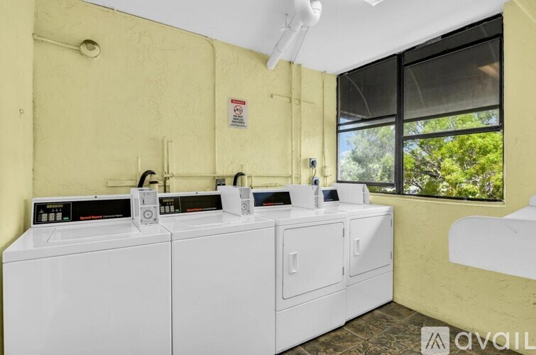 A washing machine and dryer are sitting next to each other in a small room.