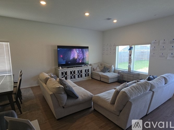 A living room with a television and two couches.