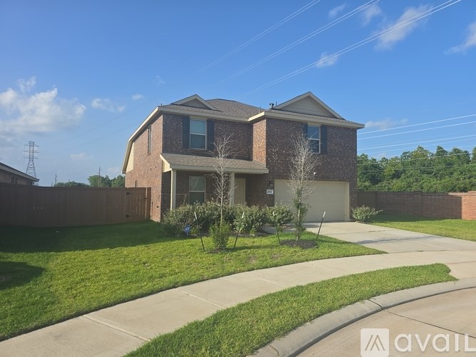 A house with a brick facade and a large front yard.