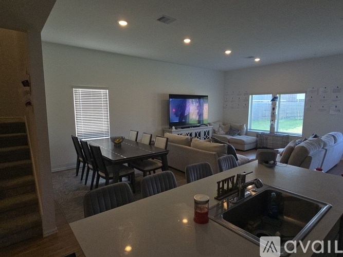 A modern kitchen with a dining table and chairs.
