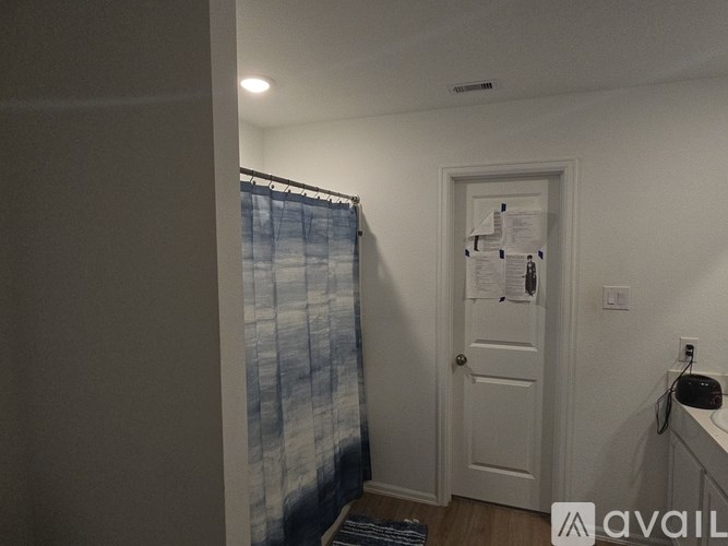 A room with a door and a window with curtains.