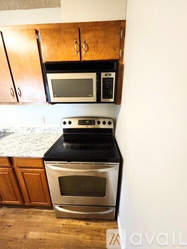 A kitchen with a stove top oven and microwave above it.