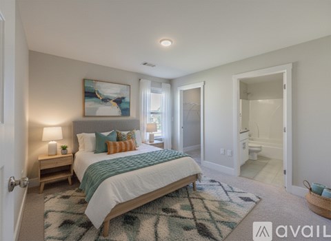 A bedroom with a large bed and a painting on the wall.