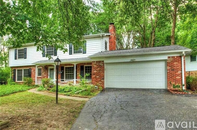 A house with a garage is for sale.