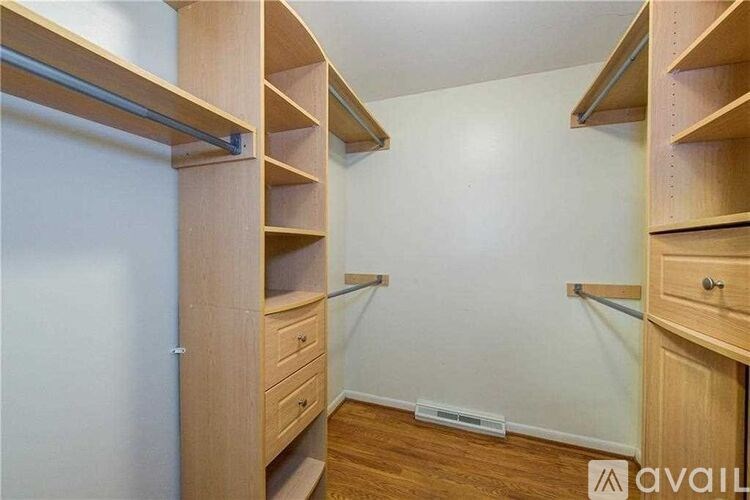 A room with bunk beds and drawers.