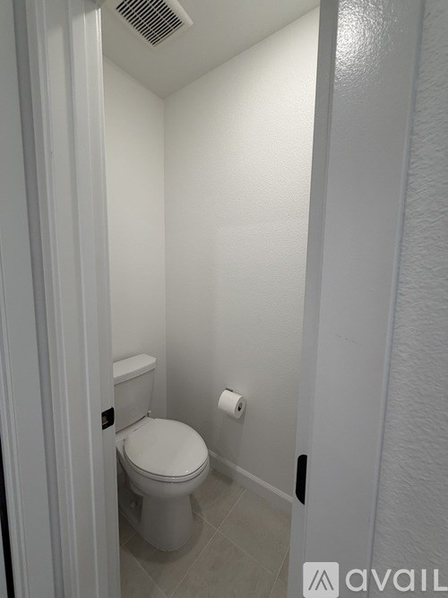 A white toilet in a small bathroom.