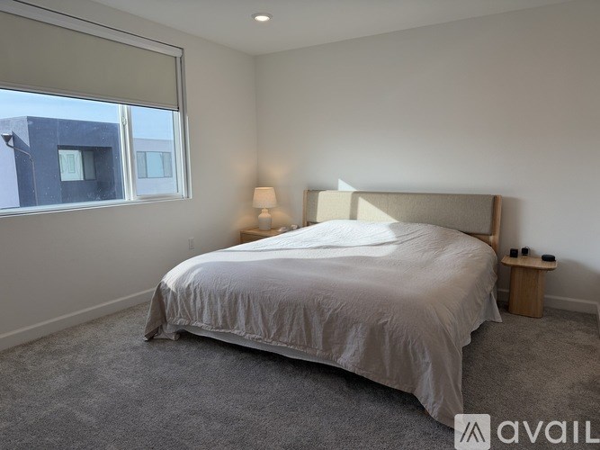 A child's bedroom with a bed, desk, and drawers.
