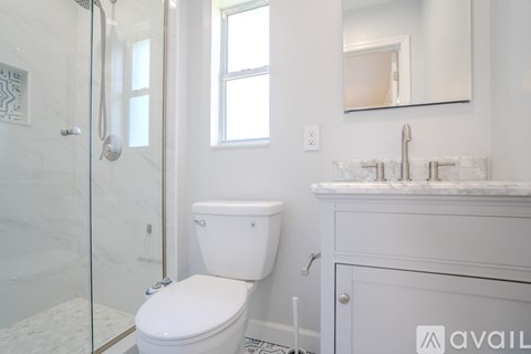 A white toilet sits next to a sink in a bathroom.