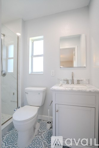 A white toilet and sink in a bathroom.
