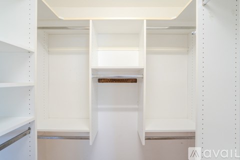 A white pantry with open shelves and a wooden counter.
