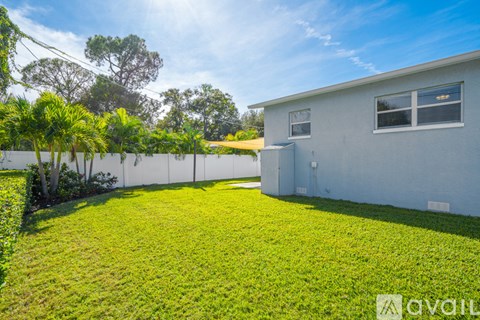 A house with a white fence and green lawn is available for rent.