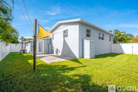 A white house with a yellow flag on a pole.