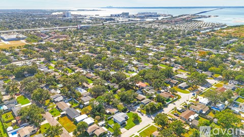 A bird's eye view of a residential area with houses and greenery.