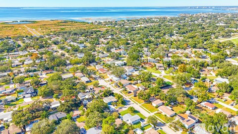 A bird's eye view of a residential area with houses and trees.